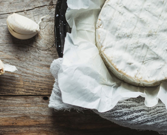 Cheese presented on a wooden table.