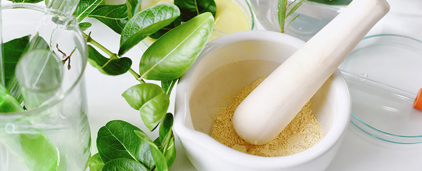 Food supplement powder in a white mortar and pestle.