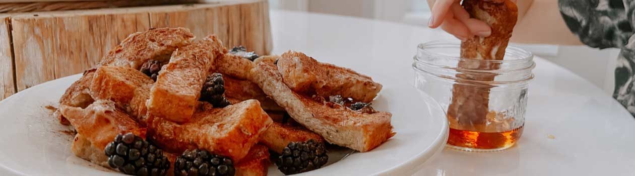 Picture displaying a plate full of tempting meat with honey on the side.